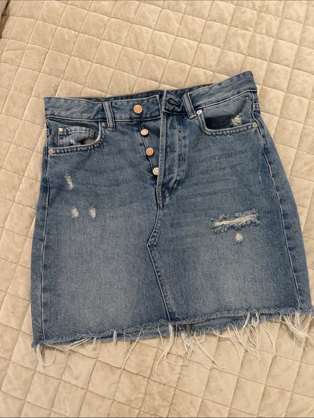 High-Rise Distressed Denim Mini Skirt in Medium Blue